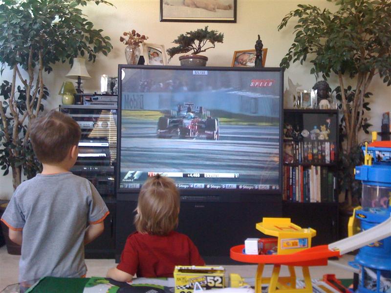 Jess_F1.jpg - Watching the Formula 1 race with Alex and Mummy!  Go Ferrari...  But wait, what's better than watching?...
